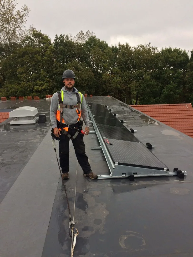 Commercial solar installer working on a business roof