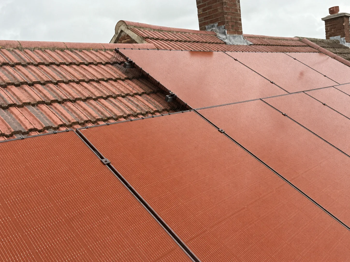 Terracotta solar panels installed on a traditional UK tiled roof