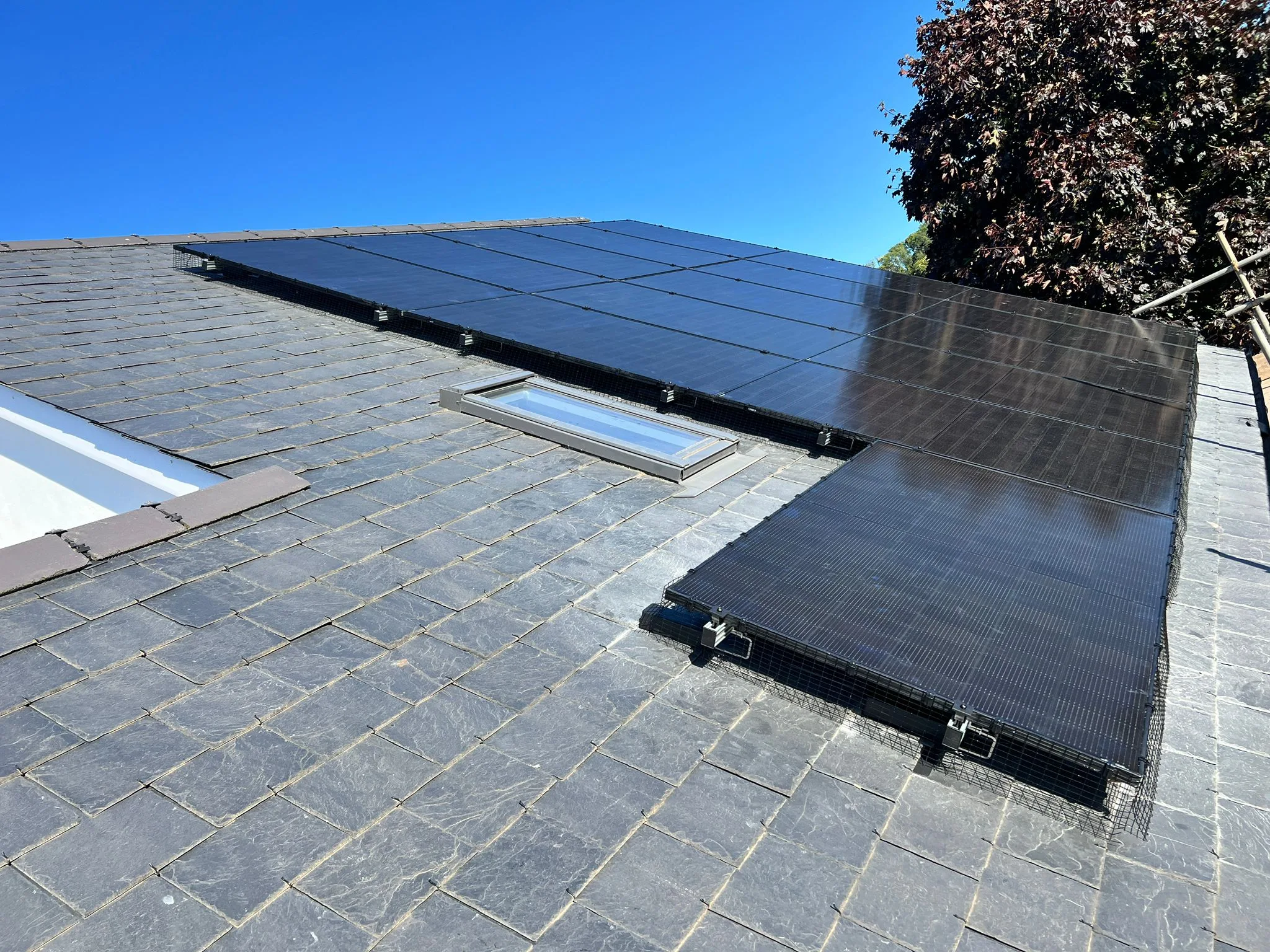 Rooftop solar panels under blue sky, representing Brighton and Sussex