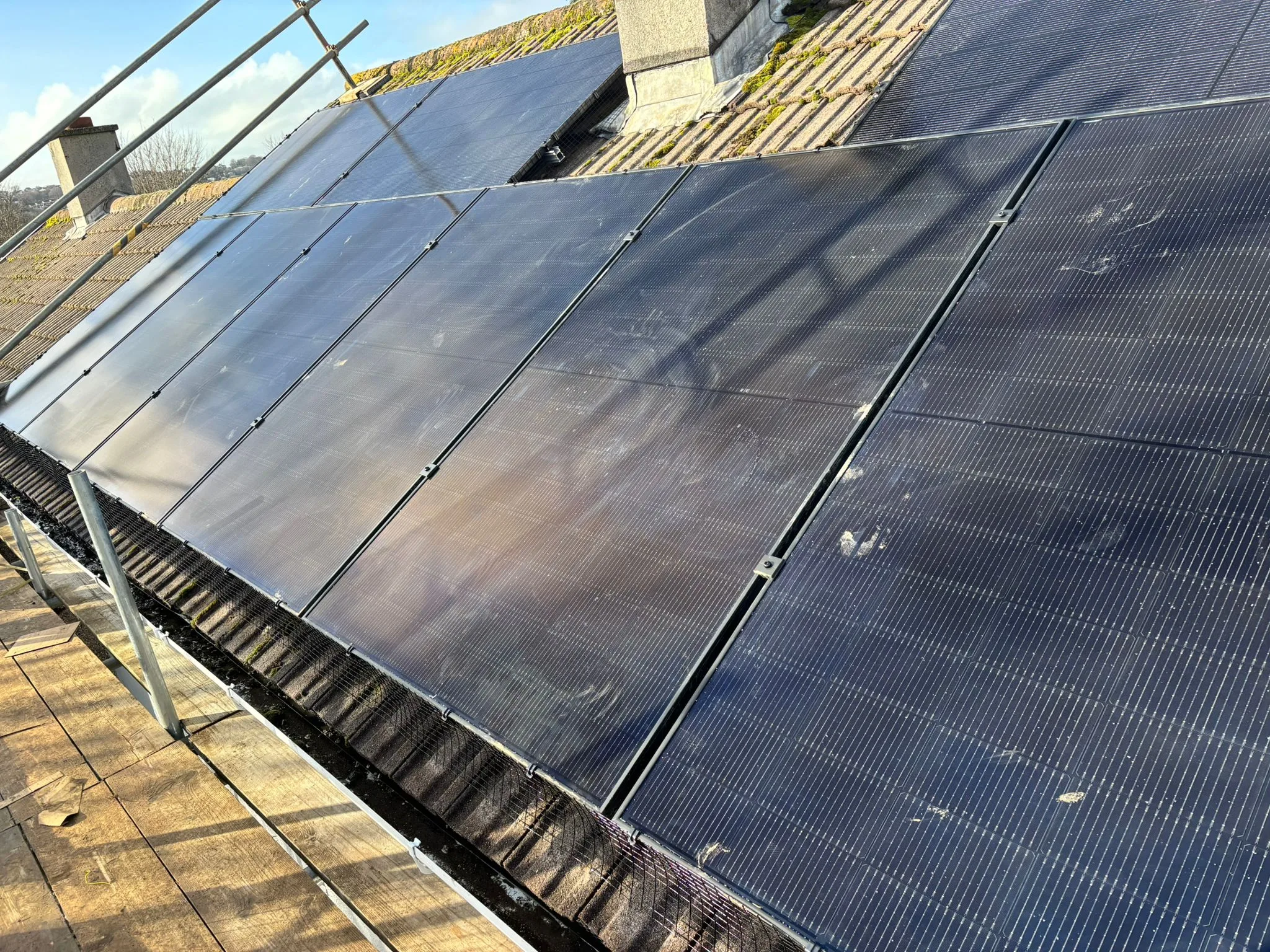 Rooftop solar panels with scaffolding, representing London