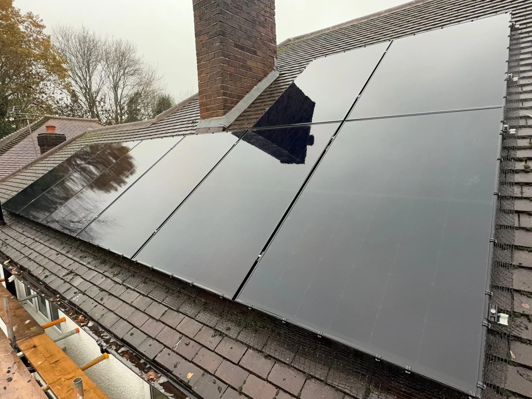 Solar panels on sloped roof, representing Manchester