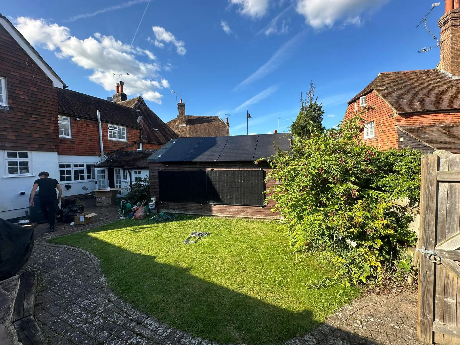 Solar panels on outbuilding in a UK garden, representing Kent