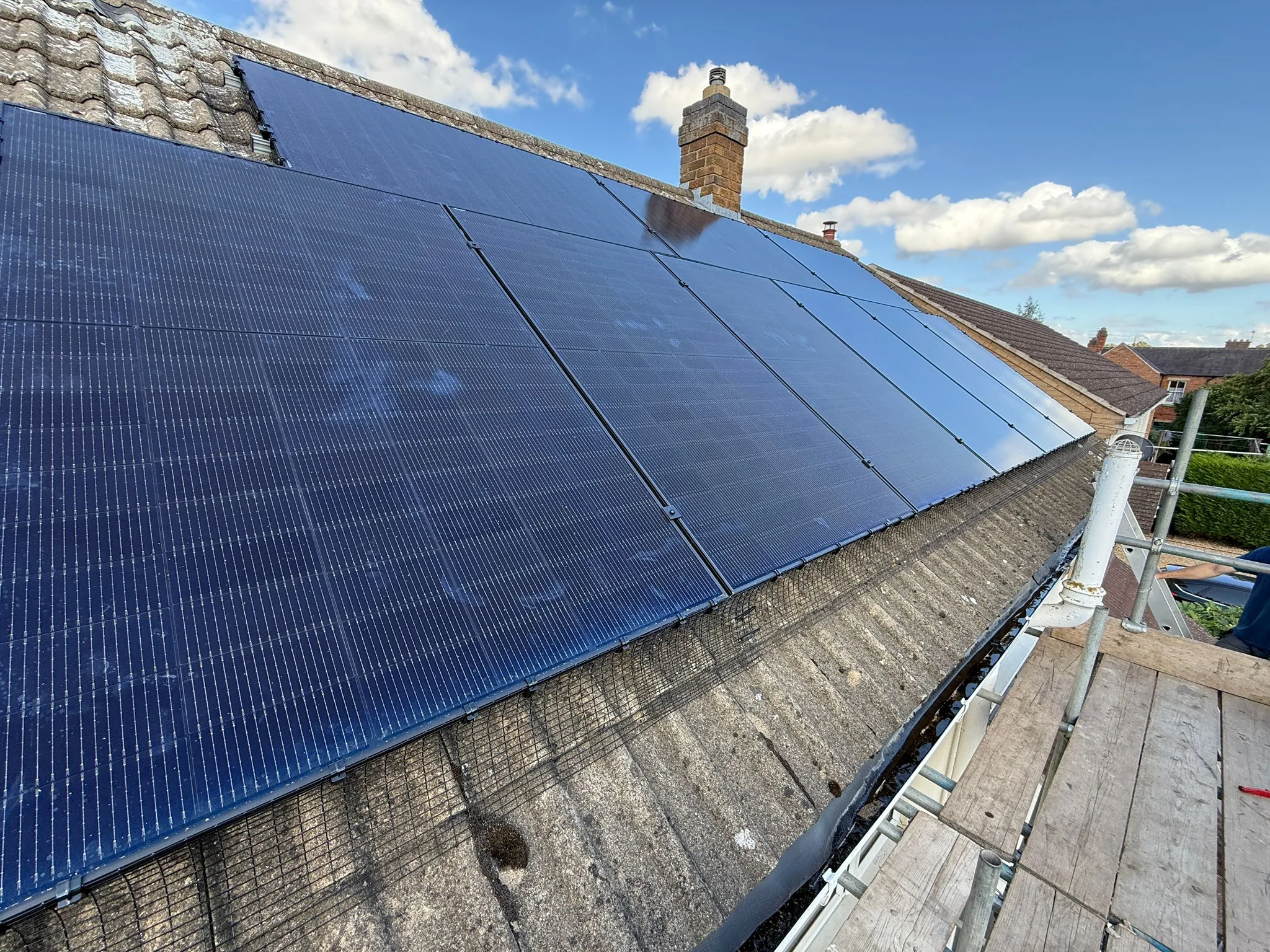Solar panels on a sloped UK roof, representing Swansea