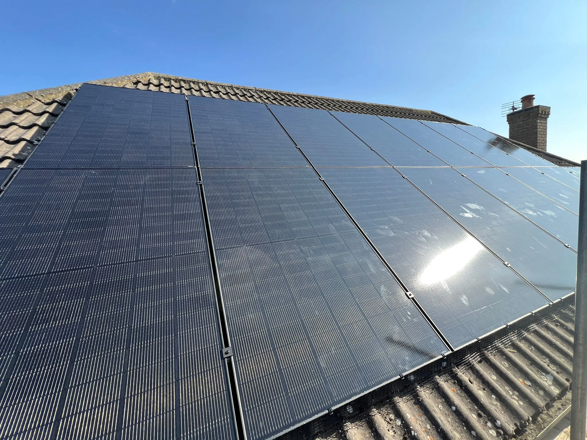 Solar roof panels on a pitched roof, representing Surrey